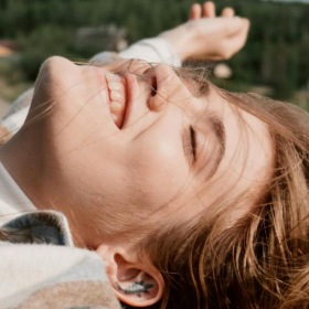 The essence of exceptional living a person wearing leaning out a window of a car smiling