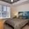 a bedroom with a bed table and a window