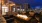 a rooftop patio with a fire pit and seating