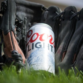 A beautiful community at the heart of all your passions a can of beer on grass in a baseball glove