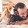 a person laying on a bed with a dog