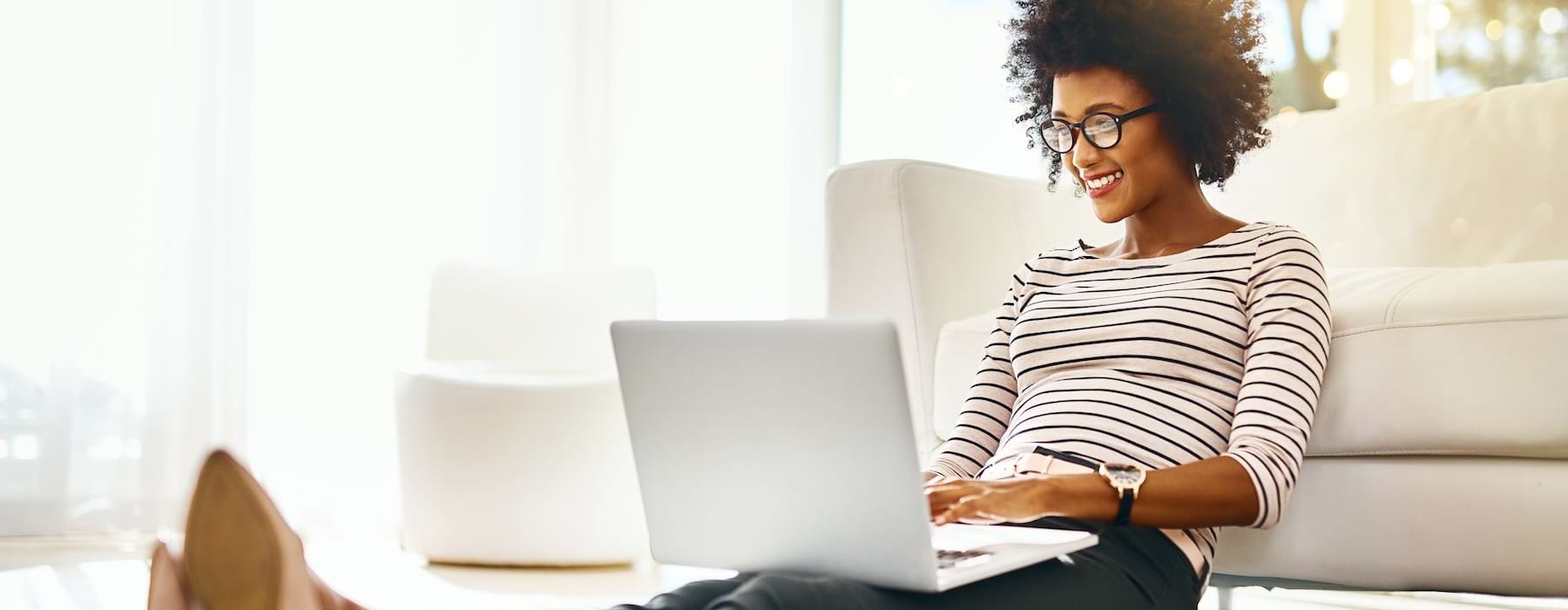 a person working on a laptop sitting on the ground