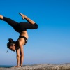 a person doing a handstand on a cliff